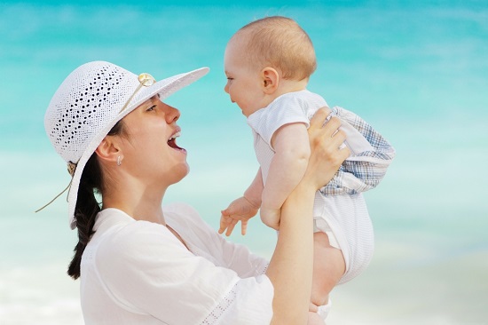 A mother smiling at her baby