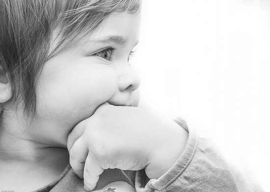 Little girl sucking on her thumb