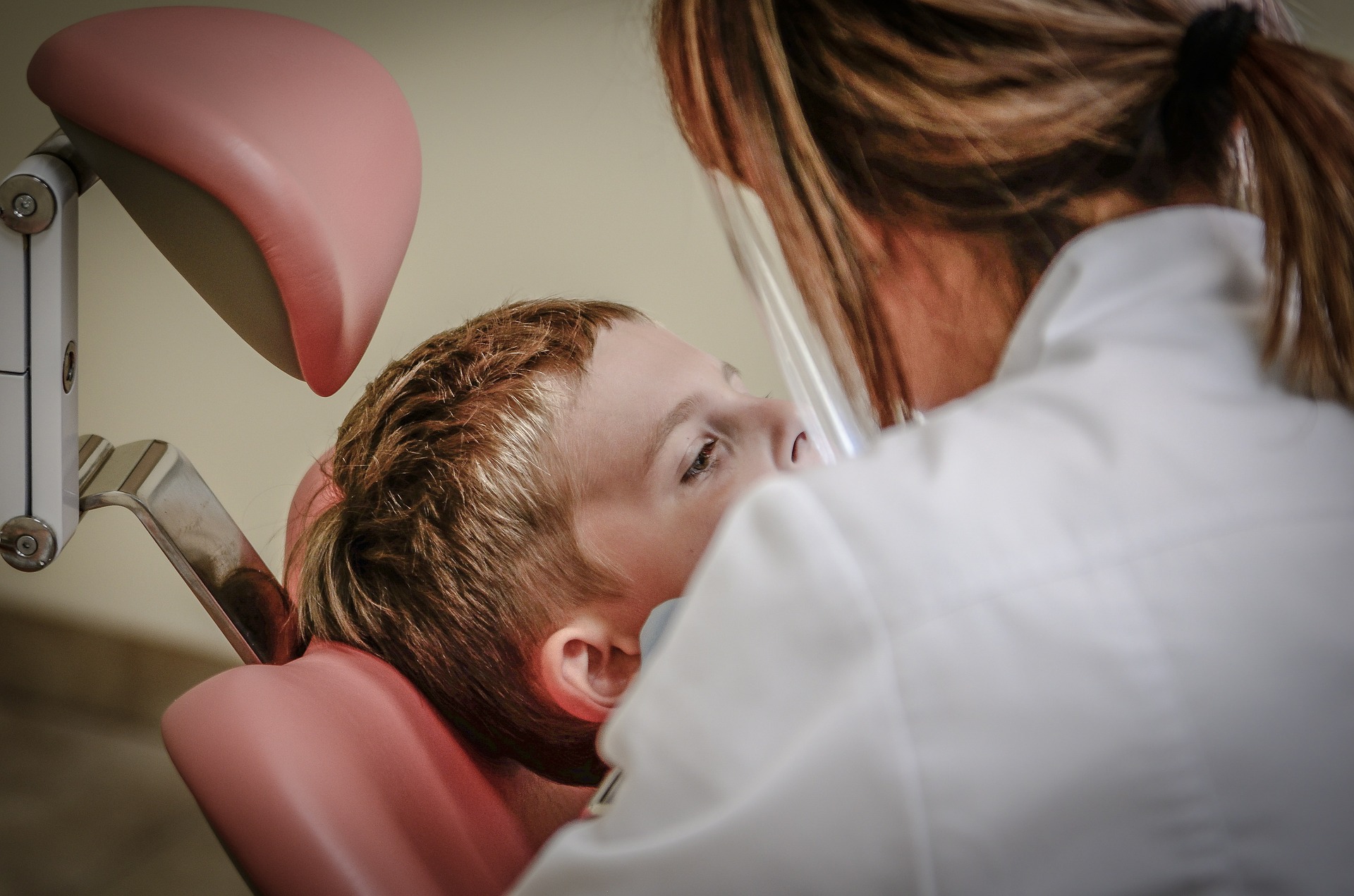 Child undergoing a dental treatment with laughing gas