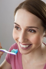 Young woman about to brush her teeth