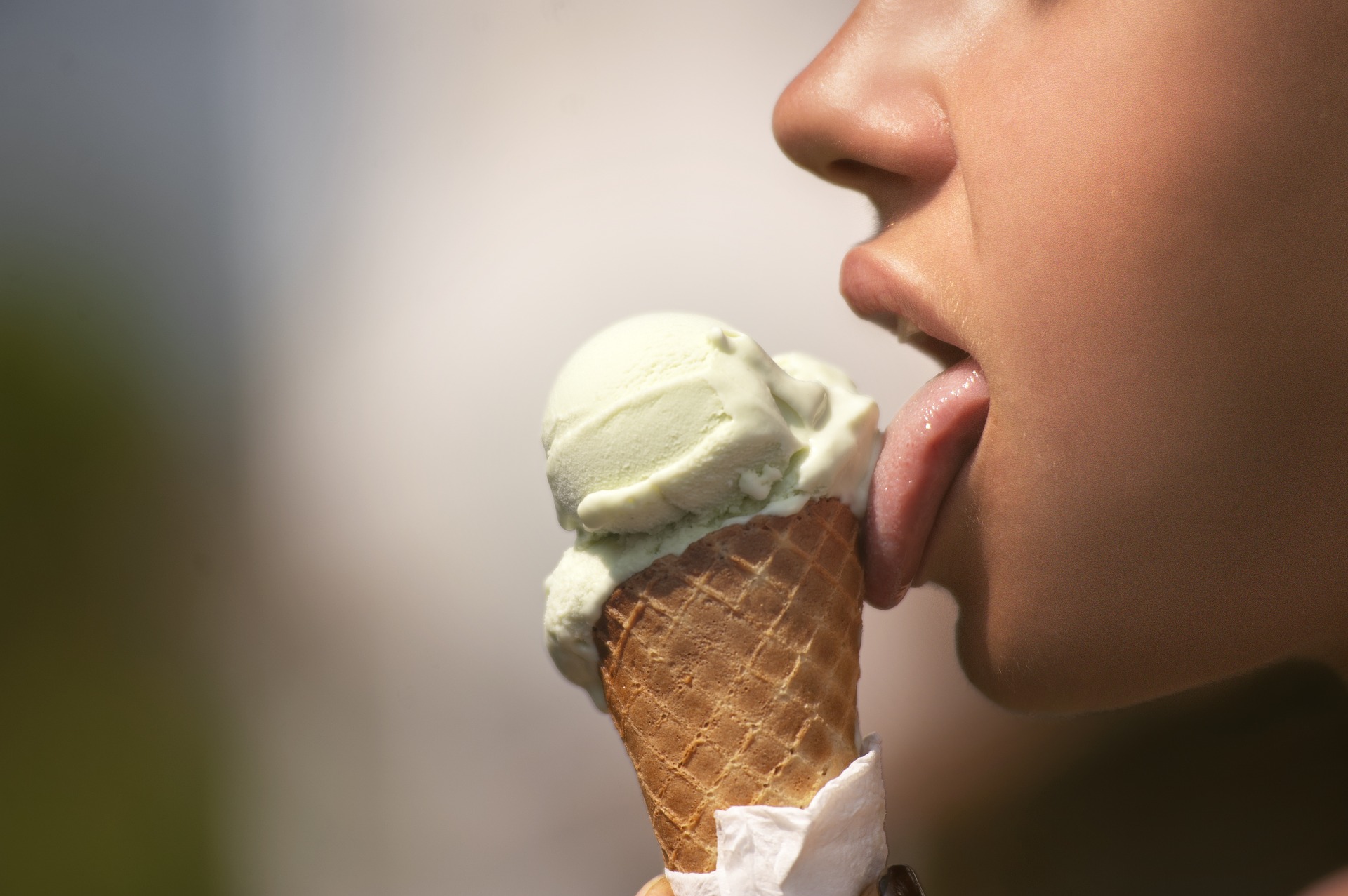 Girl eating ice cream after tongue scraping