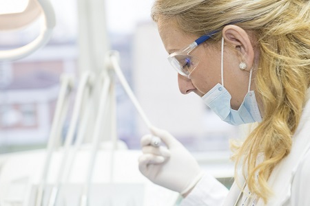 A dentist working on a dental implant